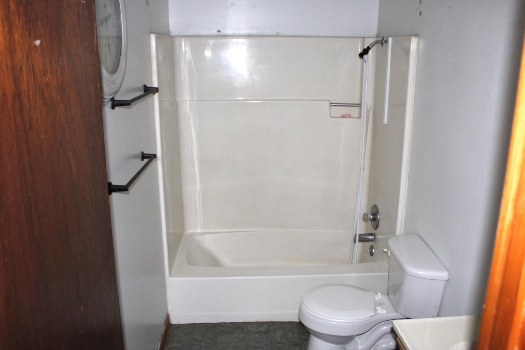 584 Chisholm Lake Road Ripley, TN 38063 - Photo 19 of 28 a bathroom with a toilet and a bathtub