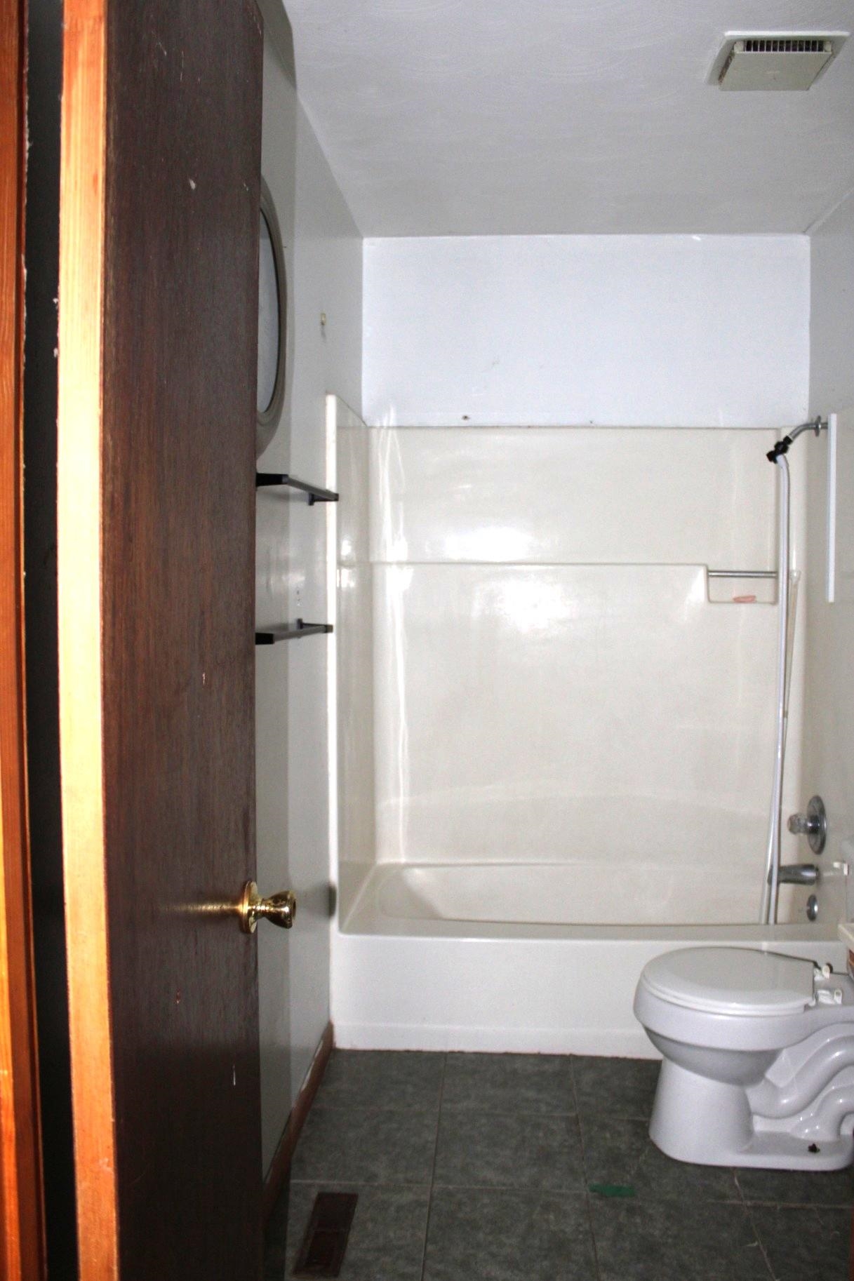 584 Chisholm Lake Road Ripley, TN 38063 - Photo 20 of 28 a bathroom with a toilet and a shower