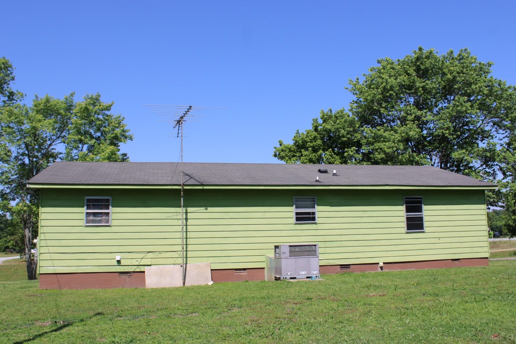 584 Chisholm Lake Road Ripley, TN 38063 - Photo 25 of 28 a view of a backyard with plants and a barbeque