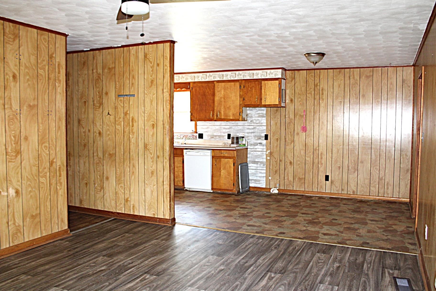 584 Chisholm Lake Road Ripley, TN 38063 - Photo 6 of 28 a view of a kitchen with wooden floor and stainless steel appliances