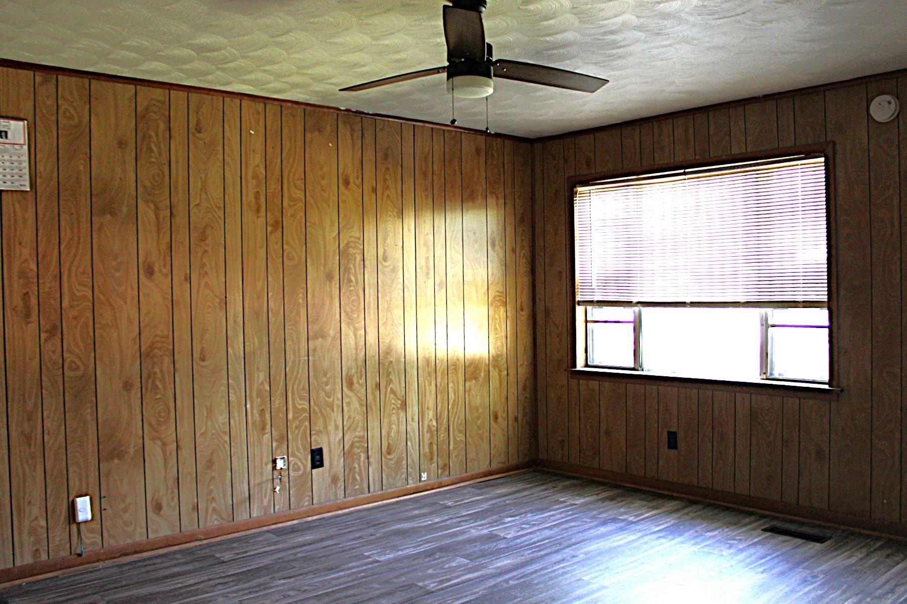 584 Chisholm Lake Road Ripley, TN 38063 - Photo 7 of 28 a view of an empty room with wooden floor and a window
