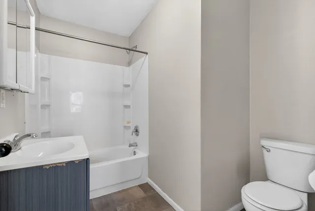 a bathroom with a bathtub a shower and a sink