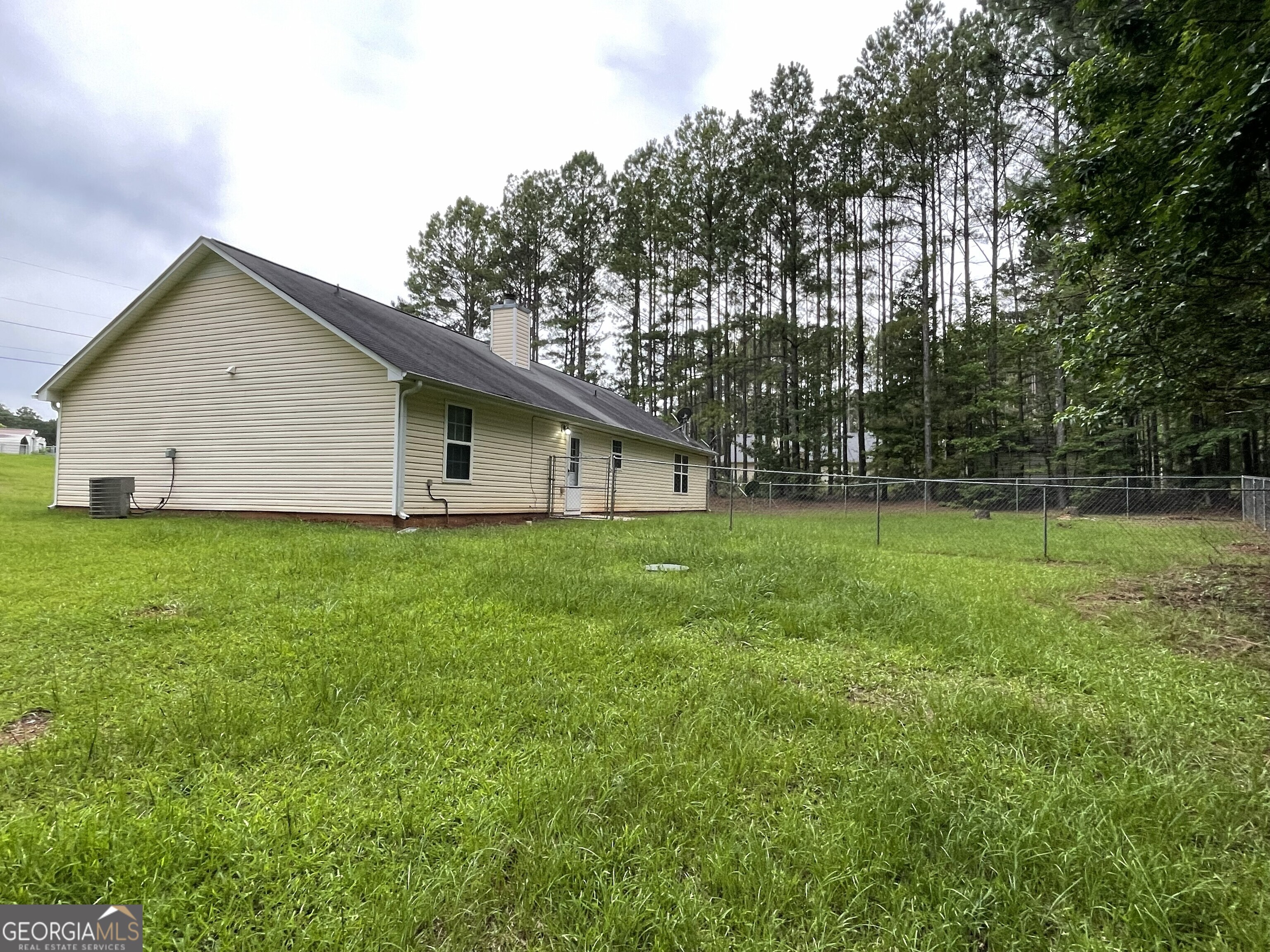 134 Cemetary Road Luthersville, GA 30251 - Photo 16 of 18 a front view of house with a garden and trees