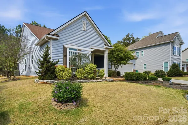 a front view of house with yard and green space