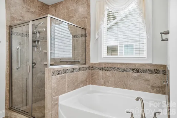 a bathroom with a bathtub and a shower