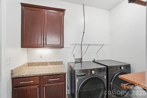 a view of house with backyard and sitting area