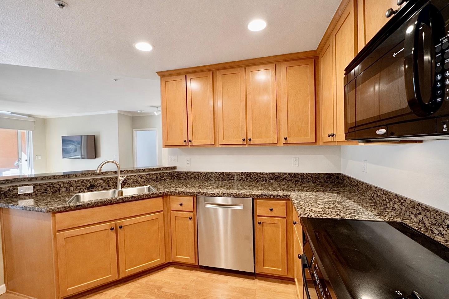 1310 Saddle Rack Street, Unit 347 San Jose, CA 95126 - Photo 10 of 42 a kitchen with granite countertop a sink a stove and cabinets