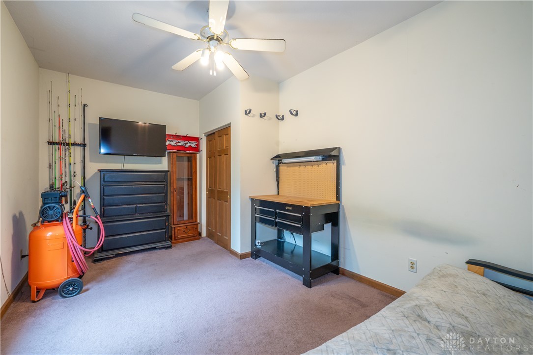 10584 New Biddinger Road Harrison, OH 45030 - Photo 24 of 61 This cozy room offers comfortable carpet flooring and a ceiling fan for optimal comfort.