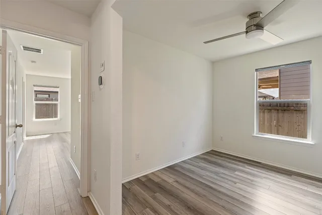 wooden floor in an empty room with a window