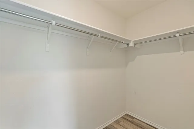 a view of a backyard with a small pool and wooden fence