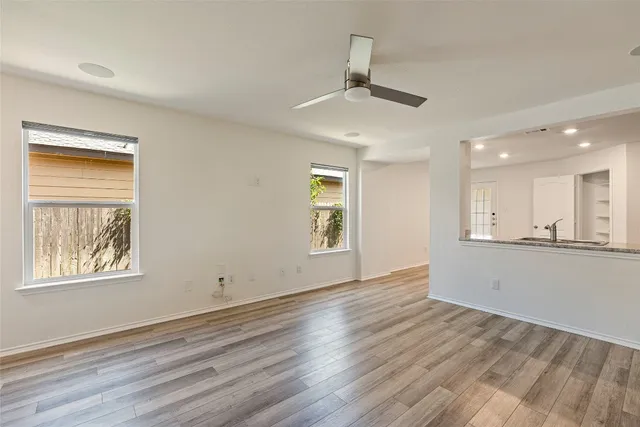 a kitchen with a refrigerator stove and wooden cabinets