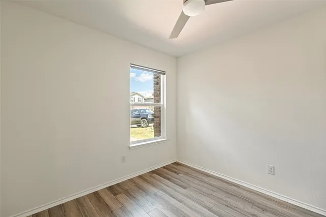 an empty room with wooden floor