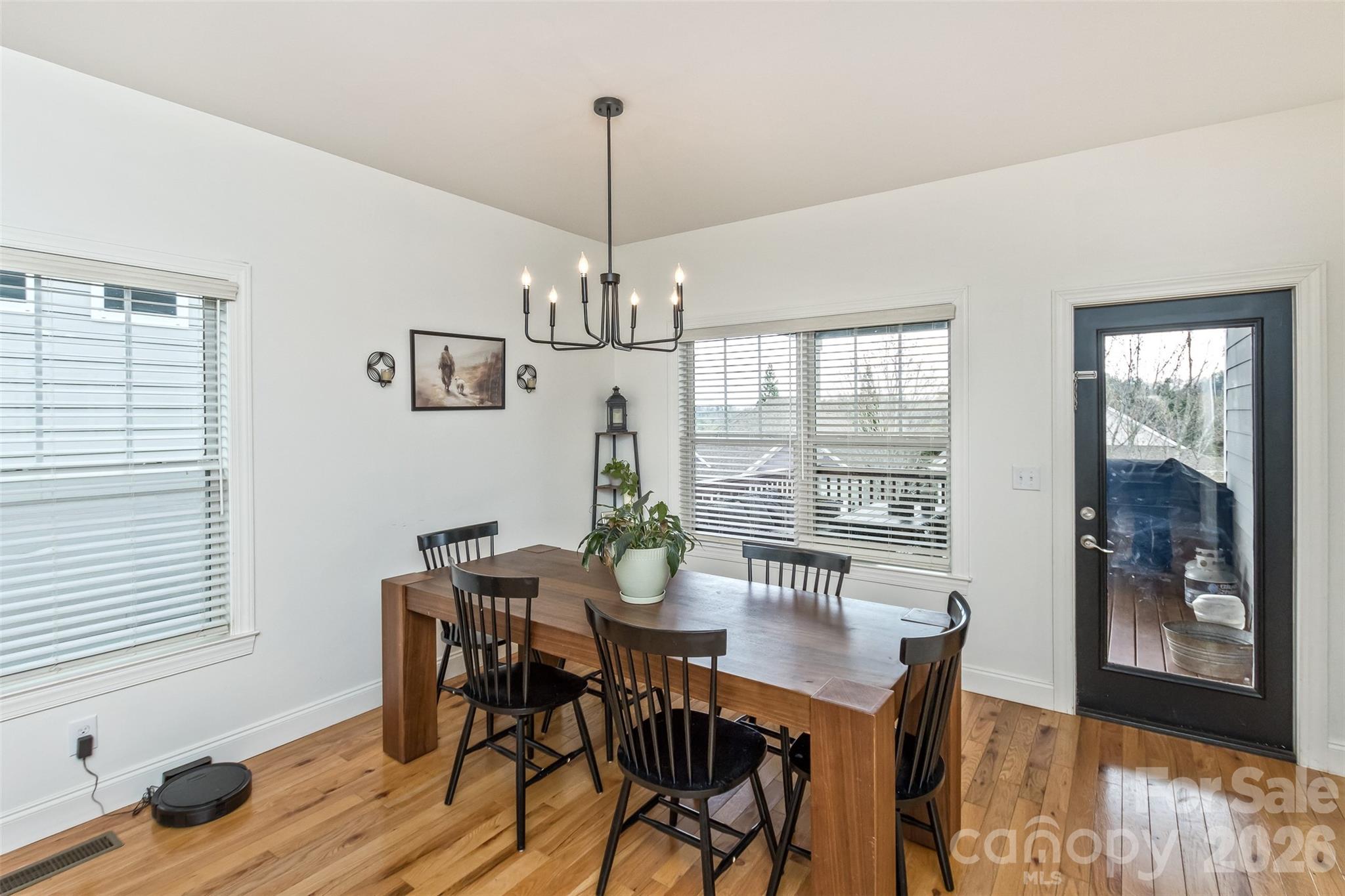 84 Rose Creek Road Leicester, NC 28748 - Photo 13 of 28 a view of a dining room with furniture window and wooden floor