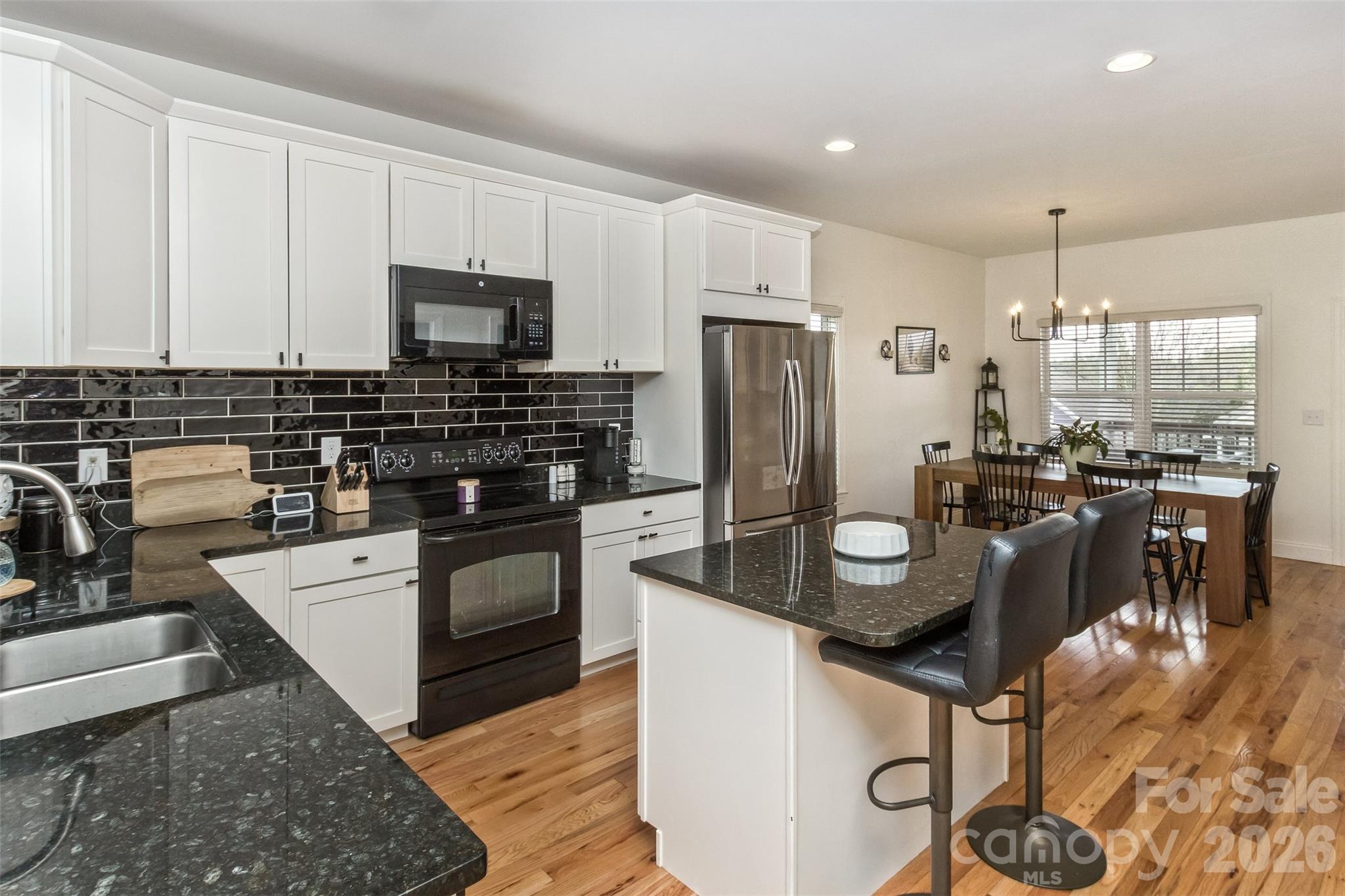 84 Rose Creek Road Leicester, NC 28748 - Photo 7 of 28 a kitchen with stainless steel appliances granite countertop a stove and a refrigerator