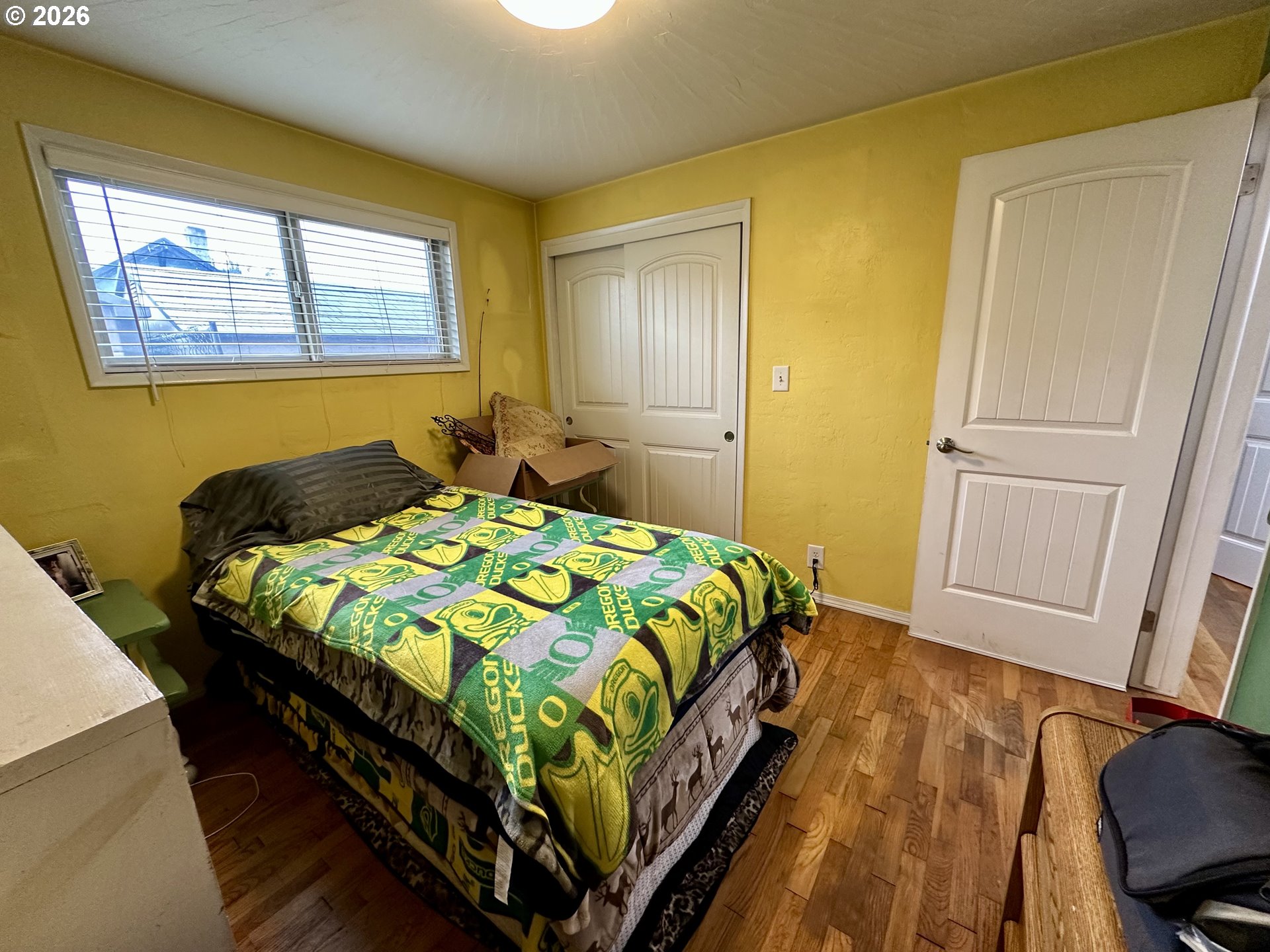 5664 Highbanks Road Springfield, OR 97478 - Photo 24 of 48 a bedroom with a bed and wooden floor