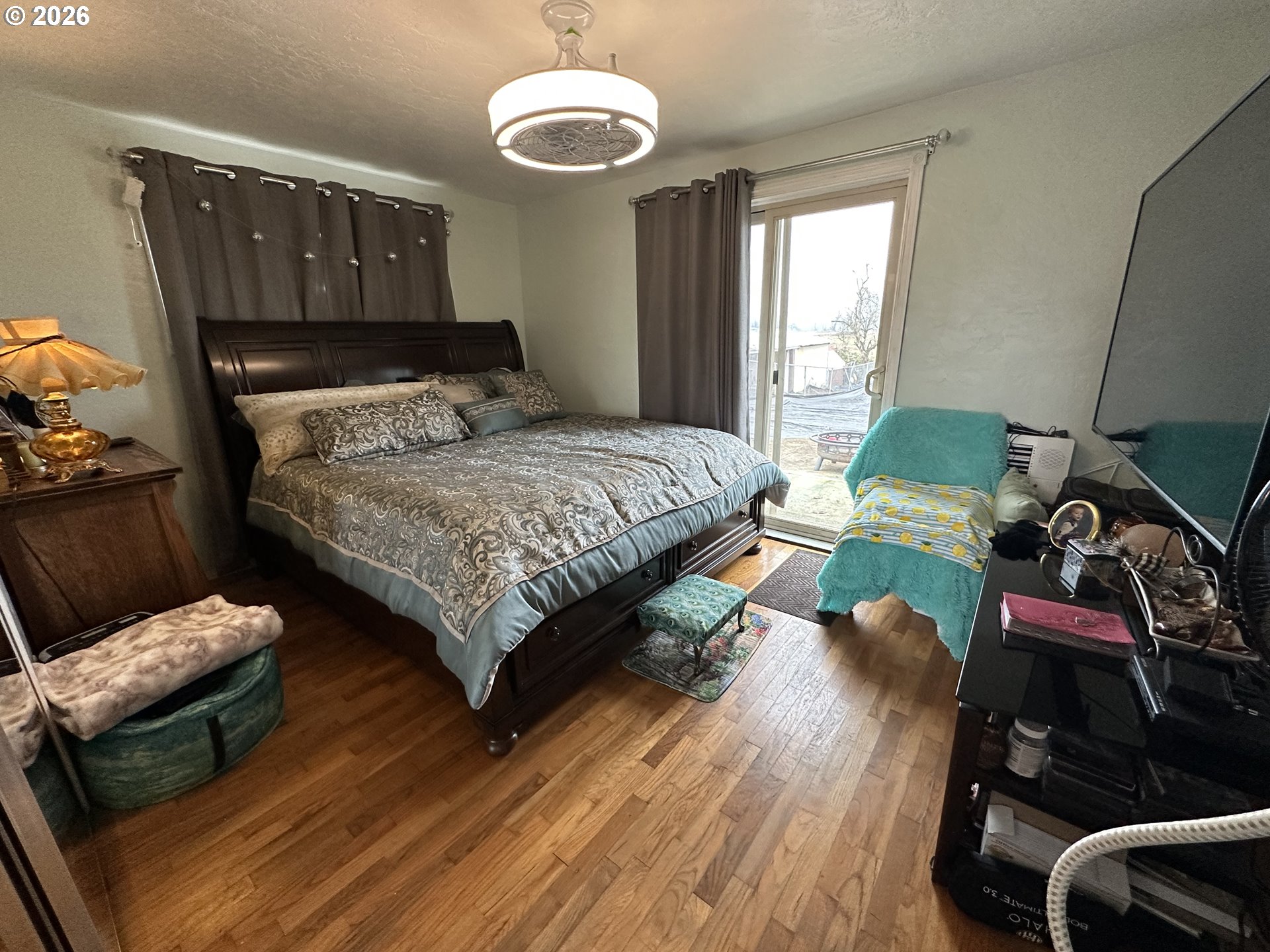 5664 Highbanks Road Springfield, OR 97478 - Photo 25 of 48 a bedroom with a bed and wooden floor