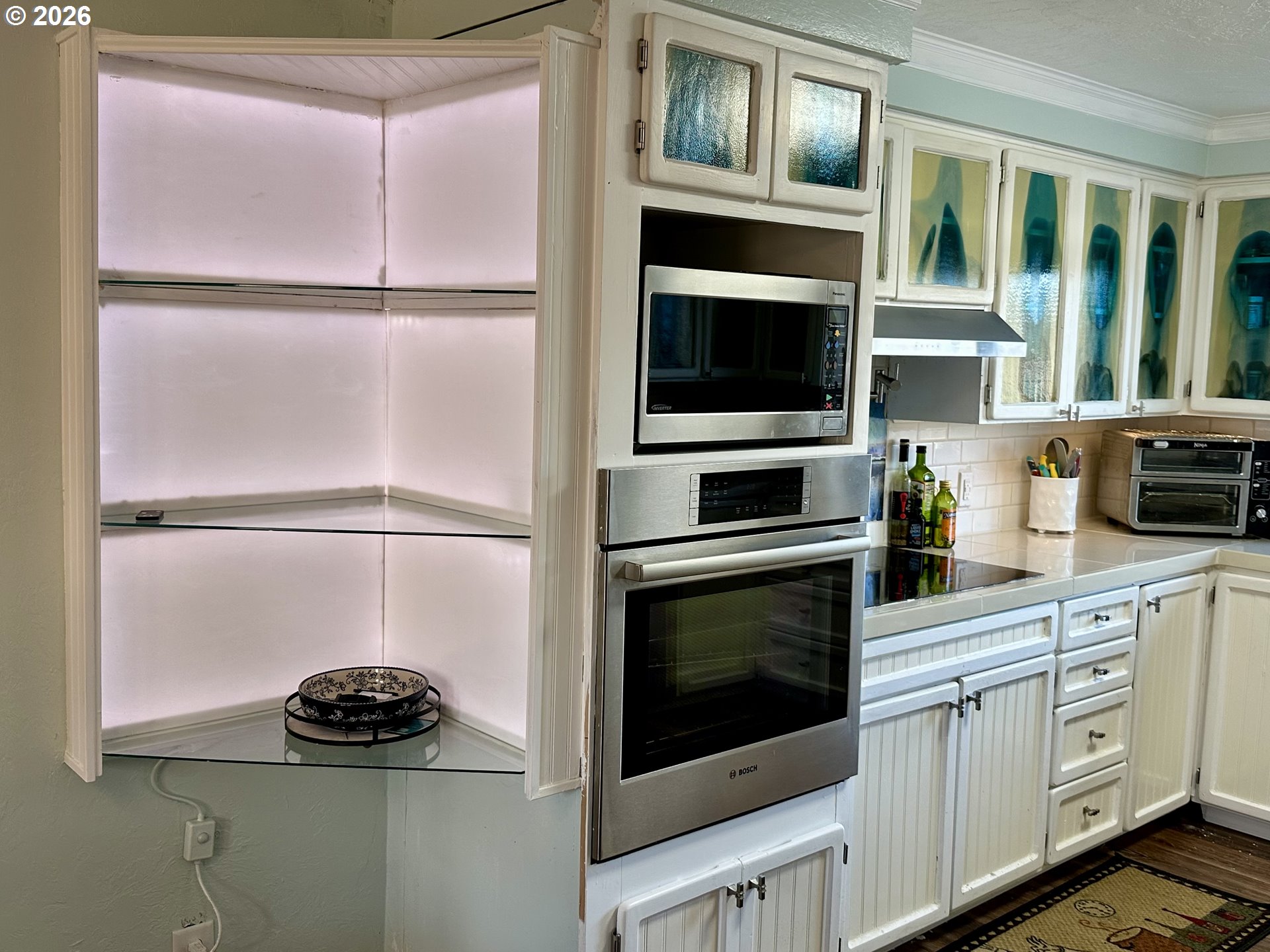 5664 Highbanks Road Springfield, OR 97478 - Photo 28 of 48 a kitchen with white cabinets and black stainless steel appliances