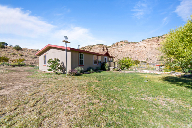 3135 North Thompson Cyn Road Green River, UT 84525 - Photo 37 of 41 Rear view of property featuring a lawn