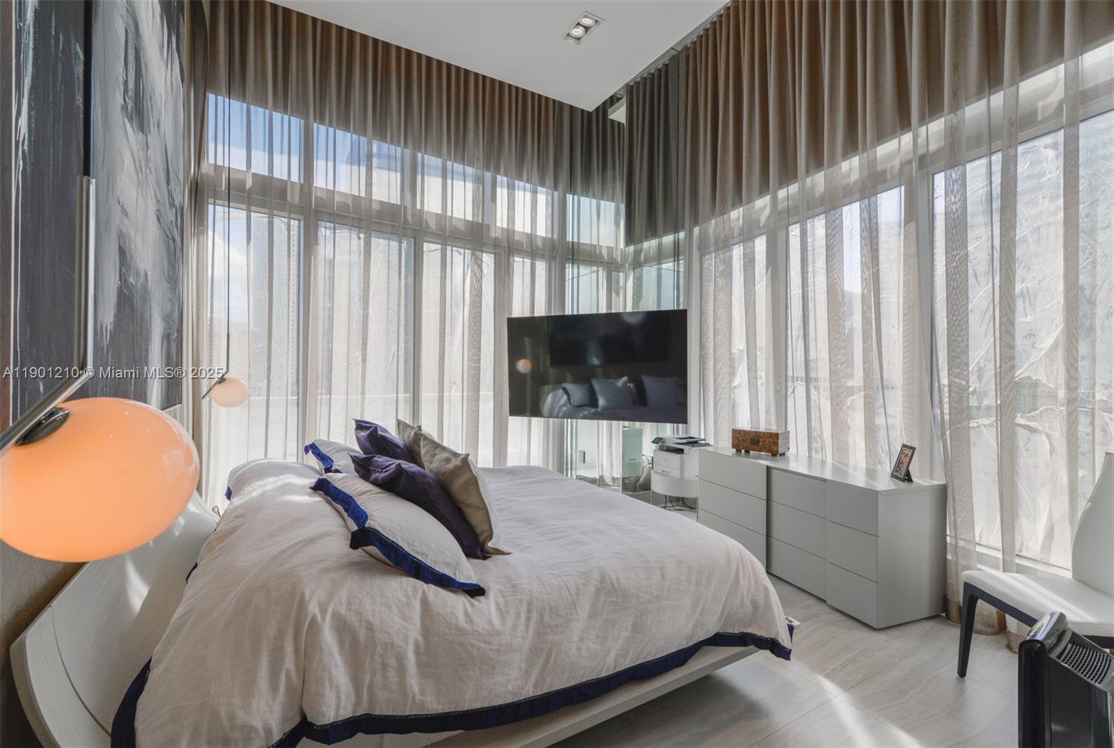 495 Brickell Avenue, Unit 2211 Miami, FL 33131 - Photo 20 of 27 a bedroom with bed and large windows