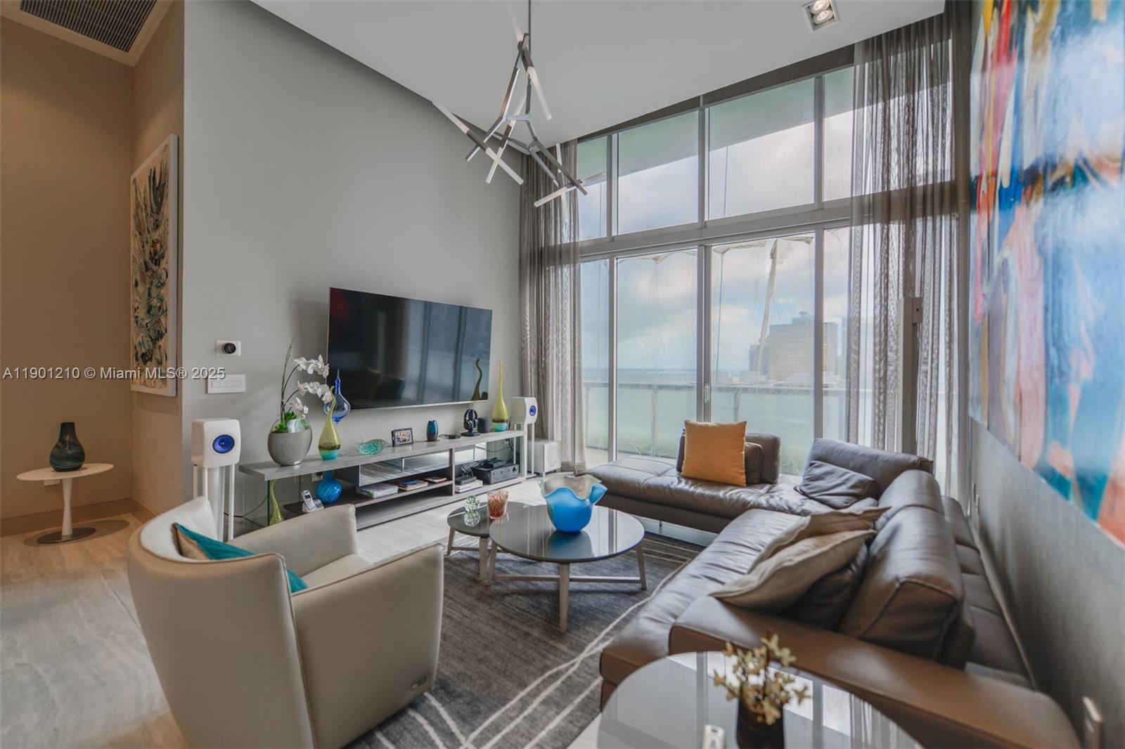 495 Brickell Avenue, Unit 2211 Miami, FL 33131 - Photo 2 of 27 a living room with furniture and a flat screen tv