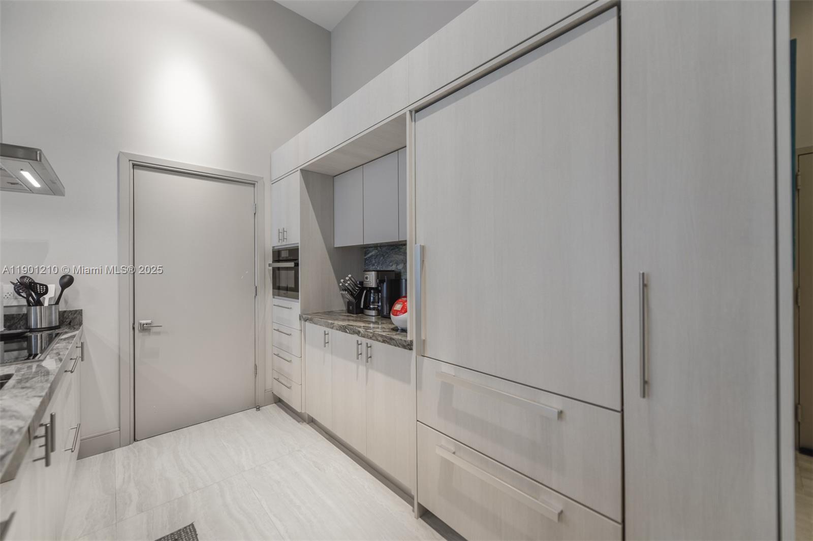 495 Brickell Avenue, Unit 2211 Miami, FL 33131 - Photo 10 of 27 a kitchen with white cabinets and white appliances