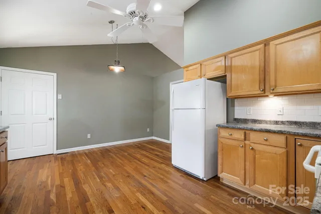 a kitchen with a refrigerator and a sink
