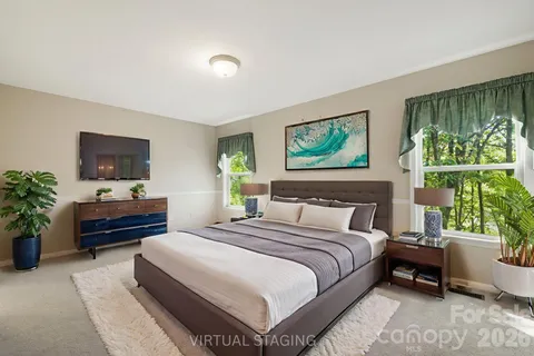 a bedroom with a bed and a large window