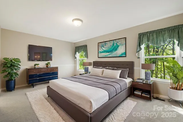 a bedroom with a bed and a large window