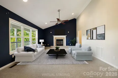 a living room with furniture windows and a fireplace