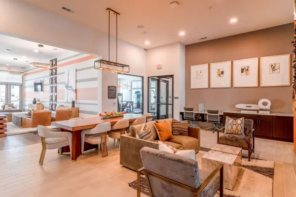 a living room with lots of furniture and a large window