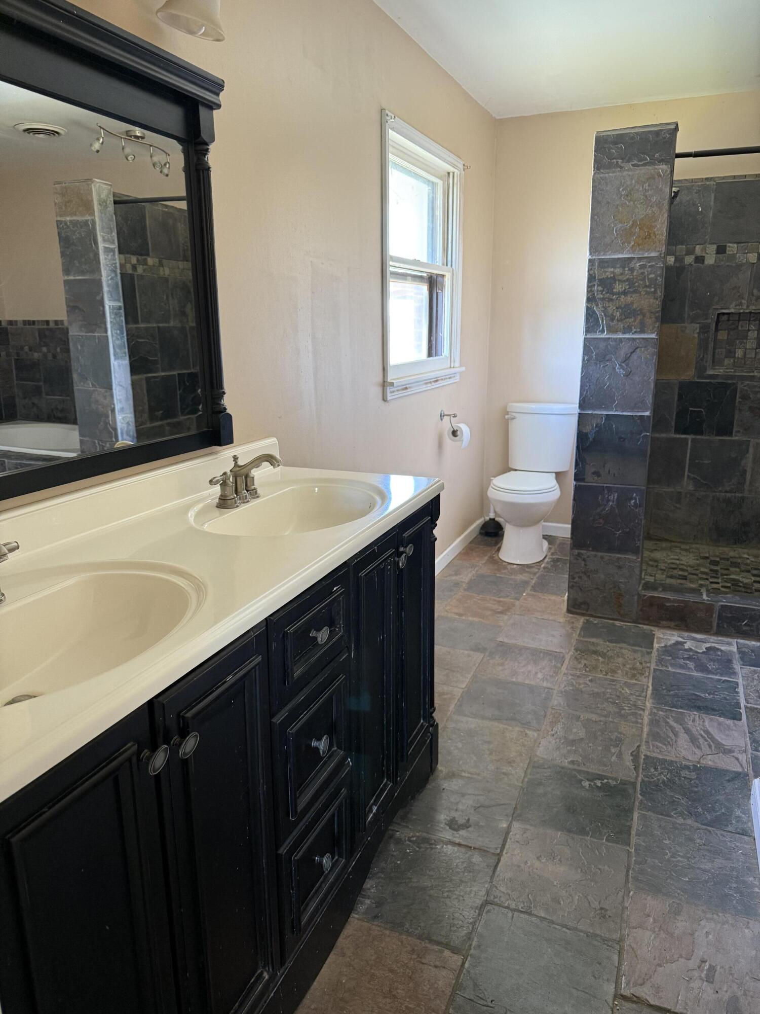 150 FM 2079 Muleshoe, TX 79347 - Photo 11 of 26 a bathroom with a sink a toilet a mirror and shower