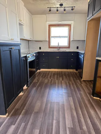 a view of a room with wooden floor