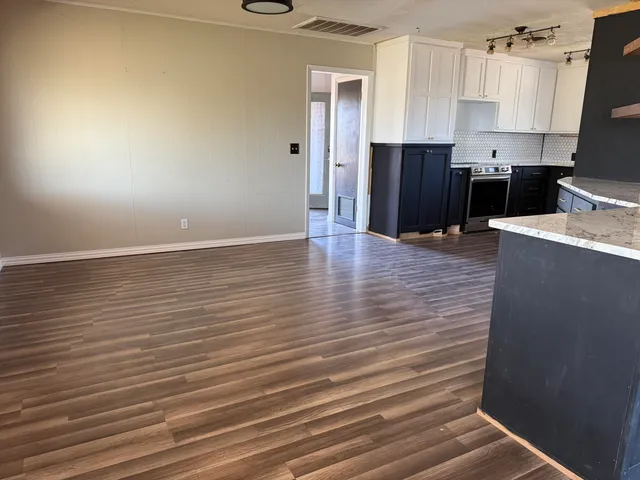 a kitchen with granite countertop a stove and a sink