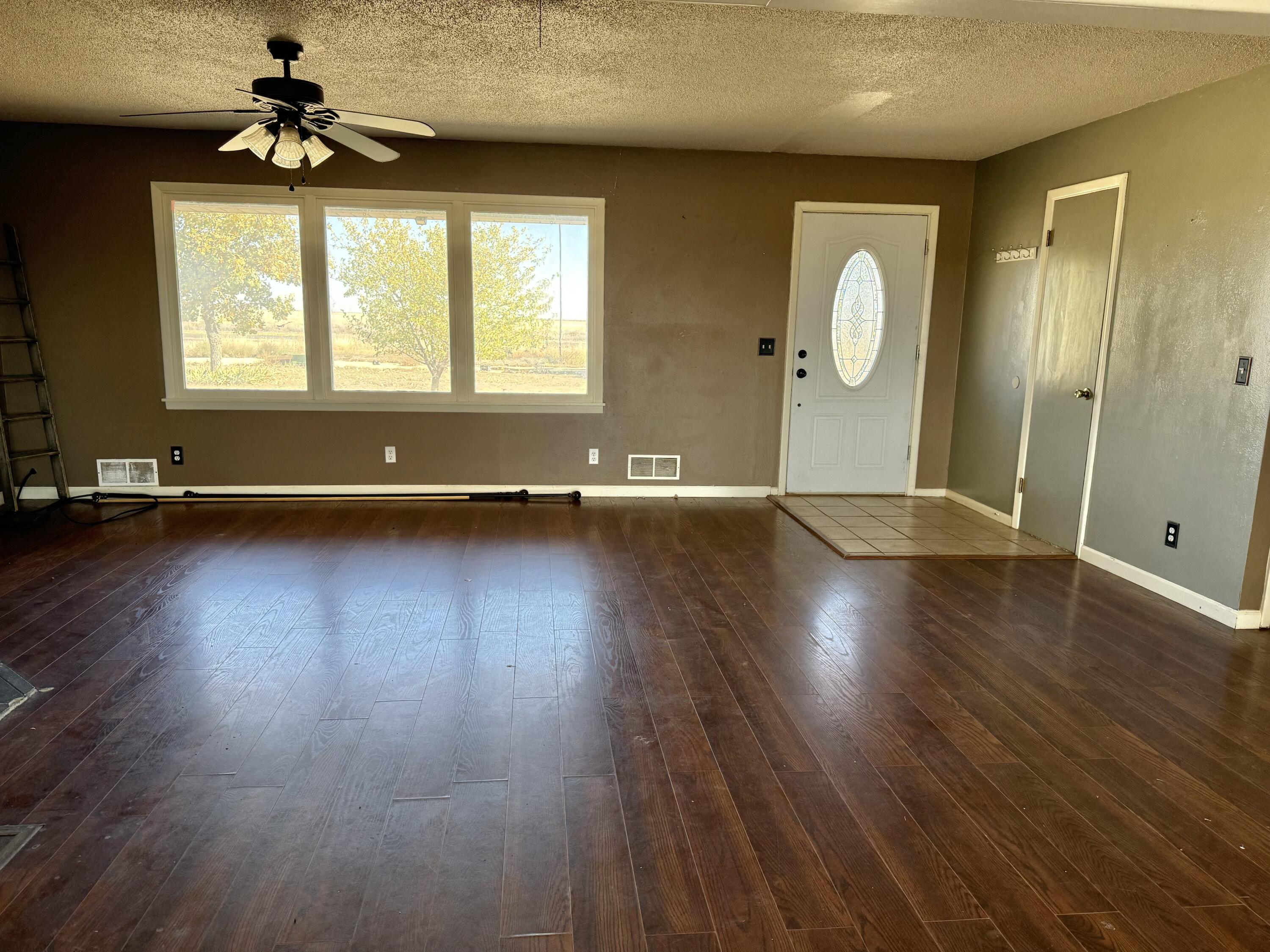 150 FM 2079 Muleshoe, TX 79347 - Photo 22 of 26 an empty room with wooden floor and windows
