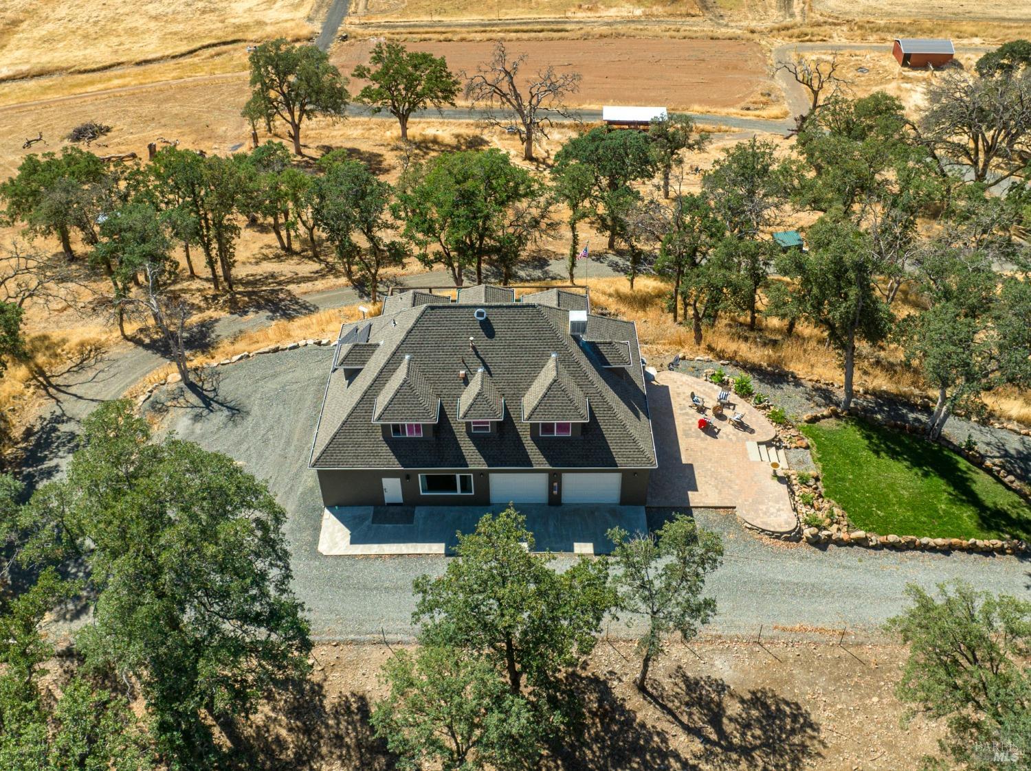 an aerial view of a house with a yard