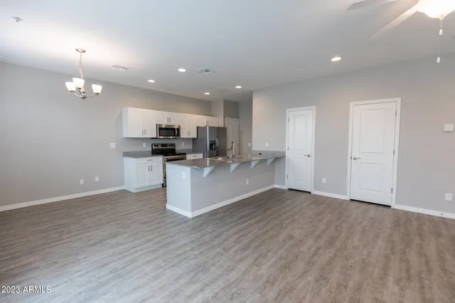 a kitchen with stainless steel appliances white cabinets a stove a sink and a microwave