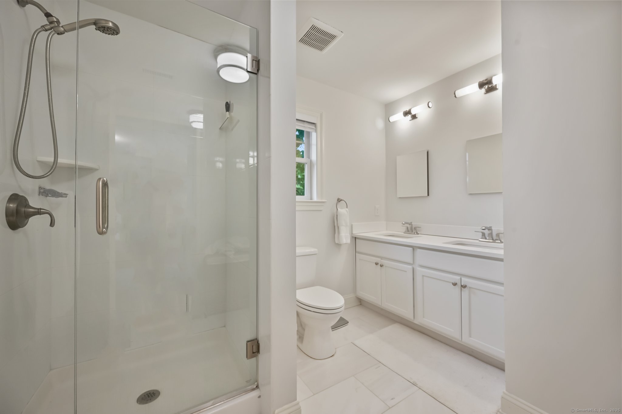 8 View Street, Unit 10 Greenwich, CT 06830 - Photo 15 of 29 a spacious bathroom with a shower sink mirror and toilet