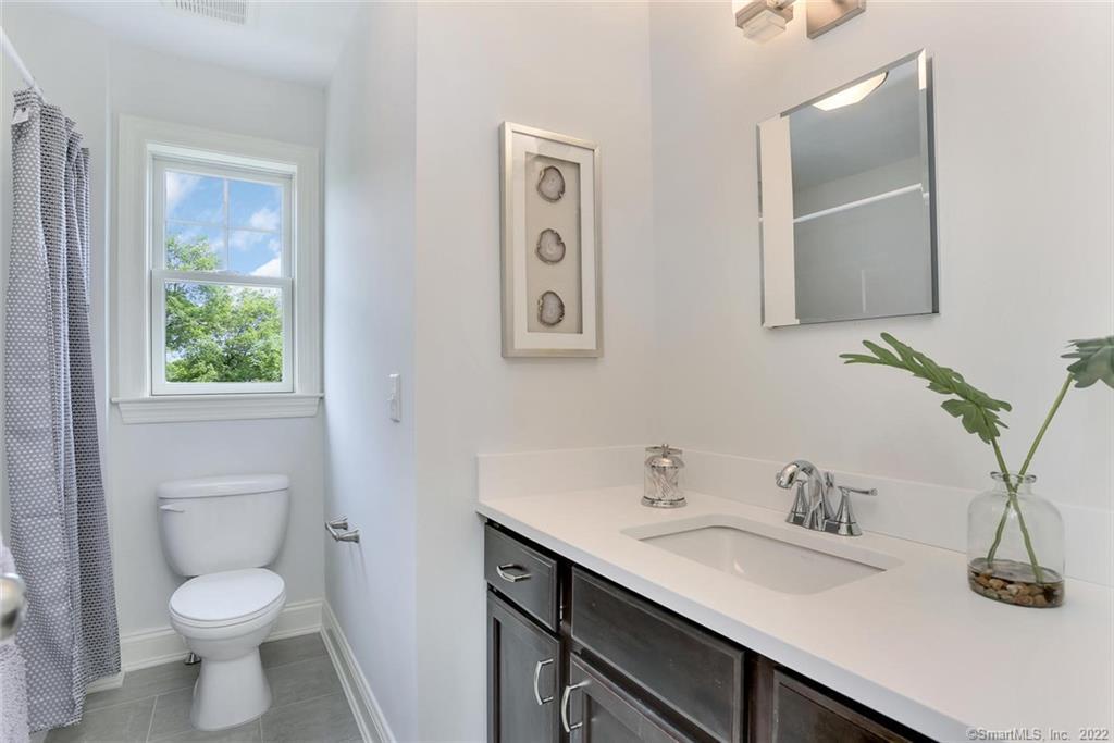 8 View Street, Unit 10 Greenwich, CT 06830 - Photo 17 of 29 a bathroom with a toilet sink and mirror