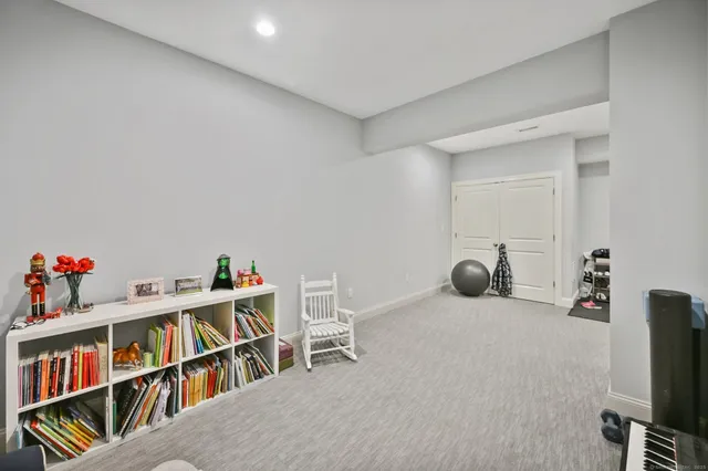 a bedroom with a bed chair and a window