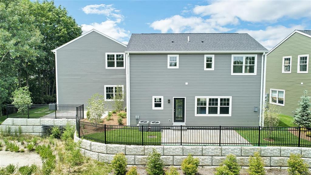 8 View Street, Unit 10 Greenwich, CT 06830 - Photo 21 of 29 a front view of a house with a yard