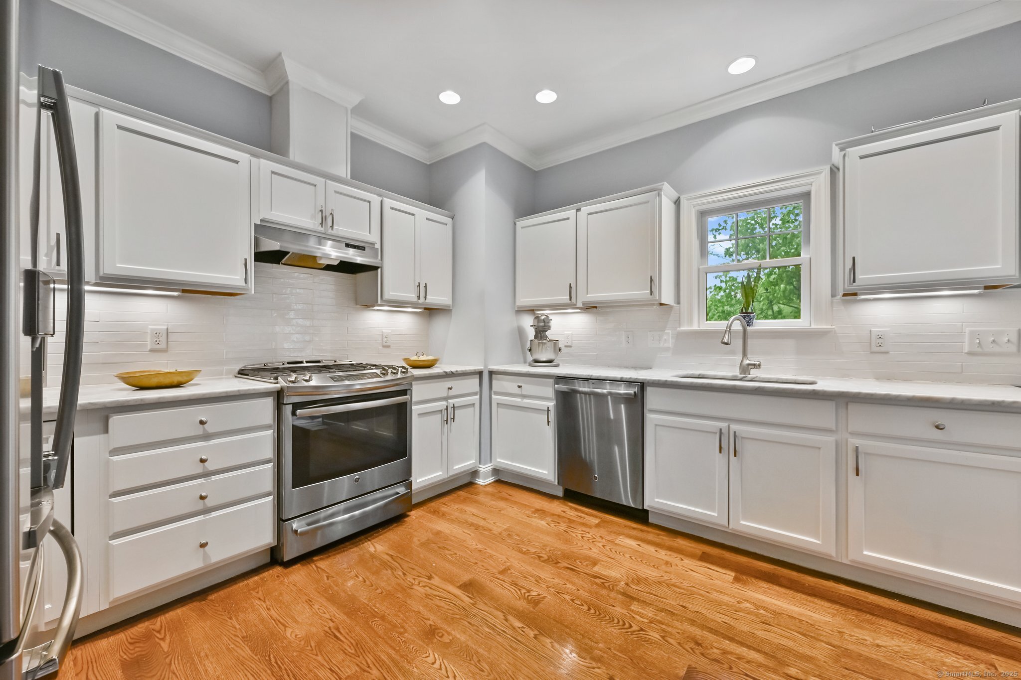 8 View Street, Unit 10 Greenwich, CT 06830 - Photo 8 of 29 a kitchen with granite countertop a sink stainless steel appliances and cabinets