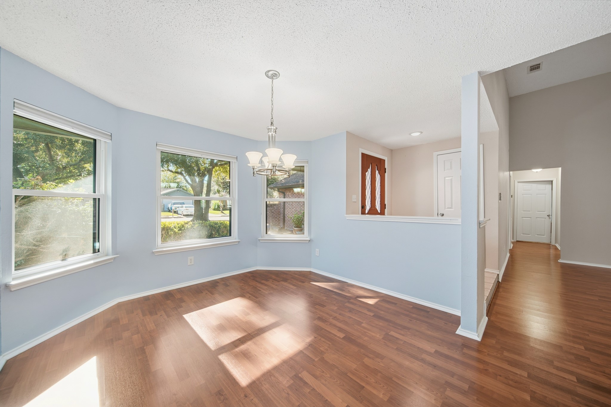 9518 Dundalk Street Spring, TX 77379 - Photo 12 of 46 a view of an empty room with wooden floor and a window