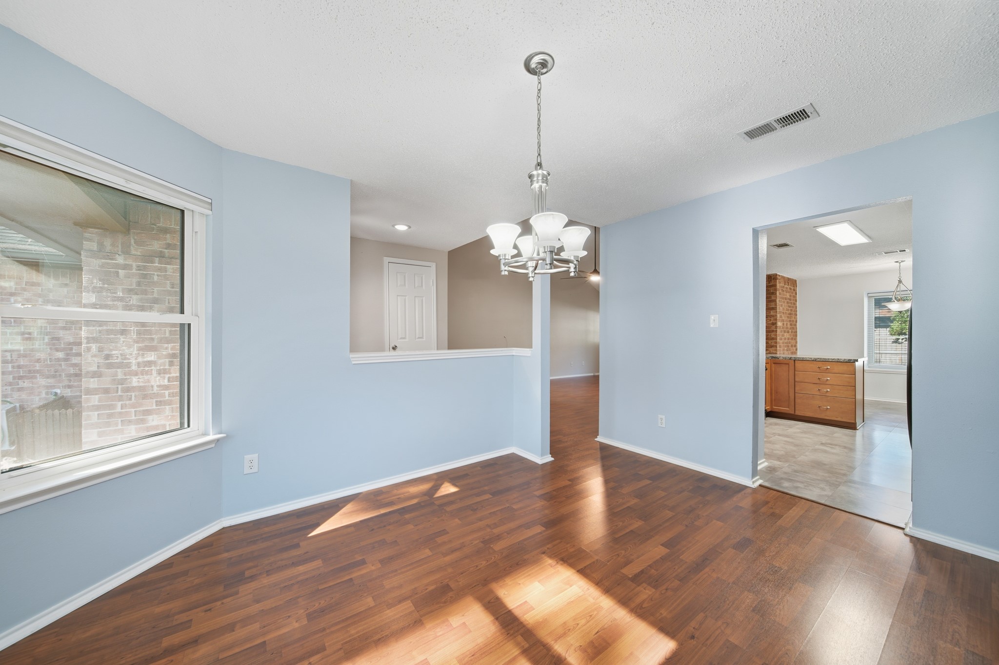 9518 Dundalk Street Spring, TX 77379 - Photo 13 of 46 a view of an empty room with wooden floor and a window