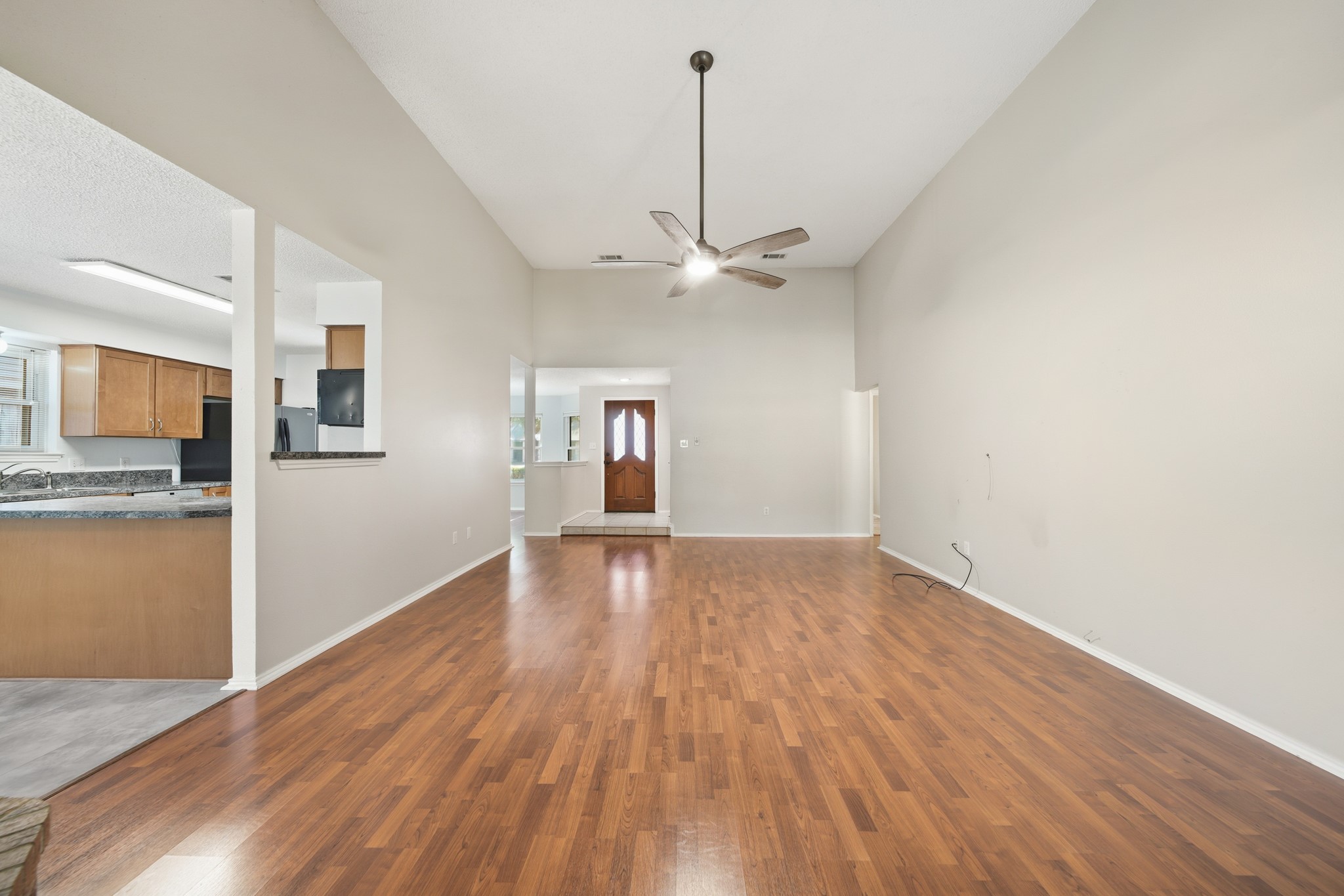 9518 Dundalk Street Spring, TX 77379 - Photo 21 of 46 a view of a room with wooden floor and a ceiling fan