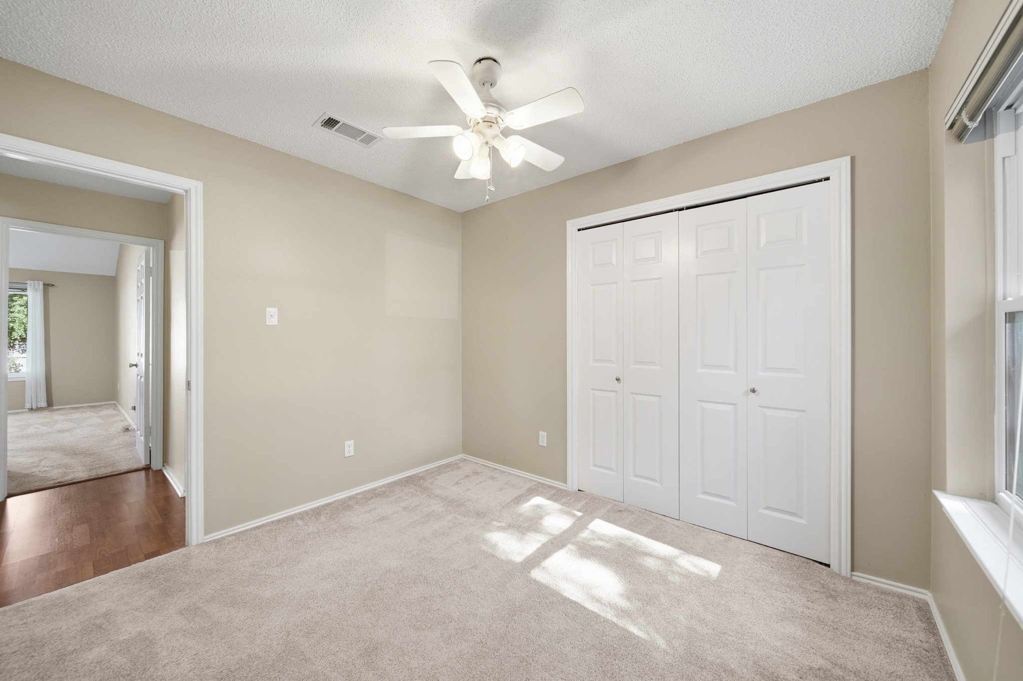 9518 Dundalk Street Spring, TX 77379 - Photo 29 of 46 a view of a big room with windows and chandelier fan