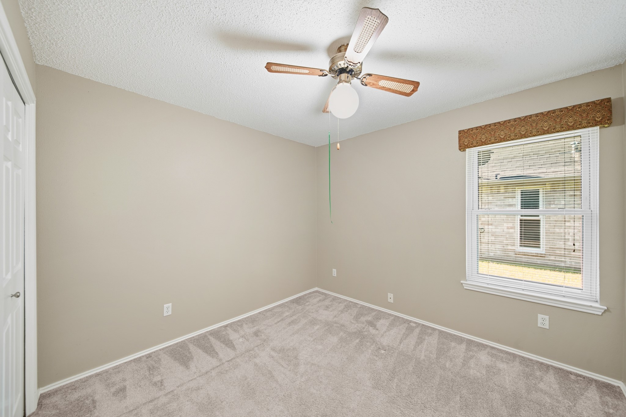 9518 Dundalk Street Spring, TX 77379 - Photo 30 of 46 an empty room with a window and a fan