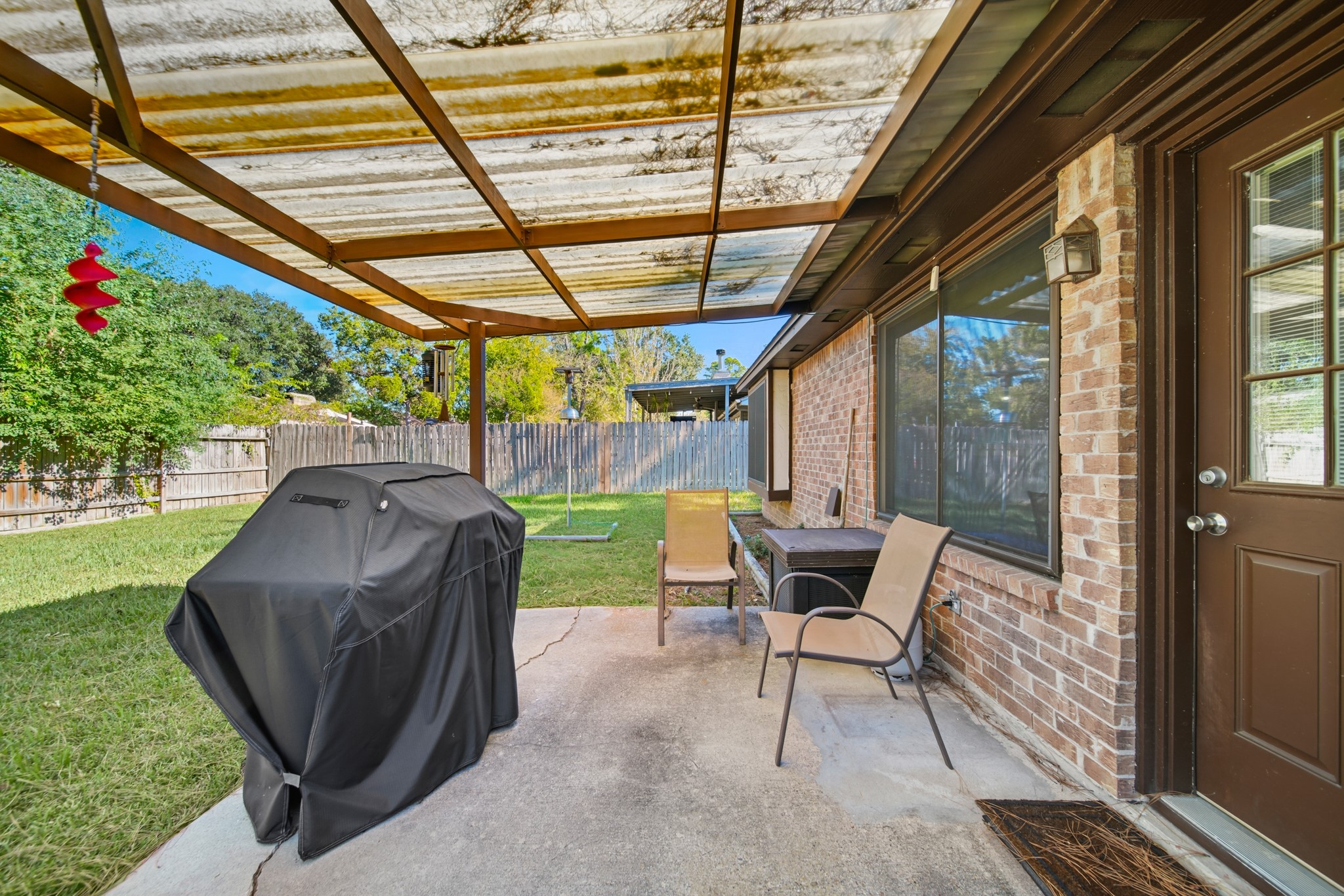 9518 Dundalk Street Spring, TX 77379 - Photo 34 of 46 a view of a chairs and table in the patio with a backyard