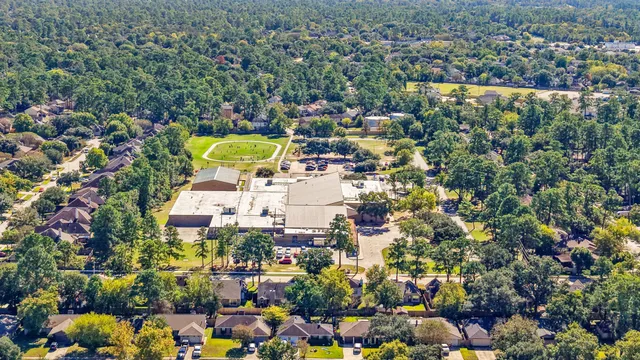 an aerial view of residential house with outdoor space and swimming pool