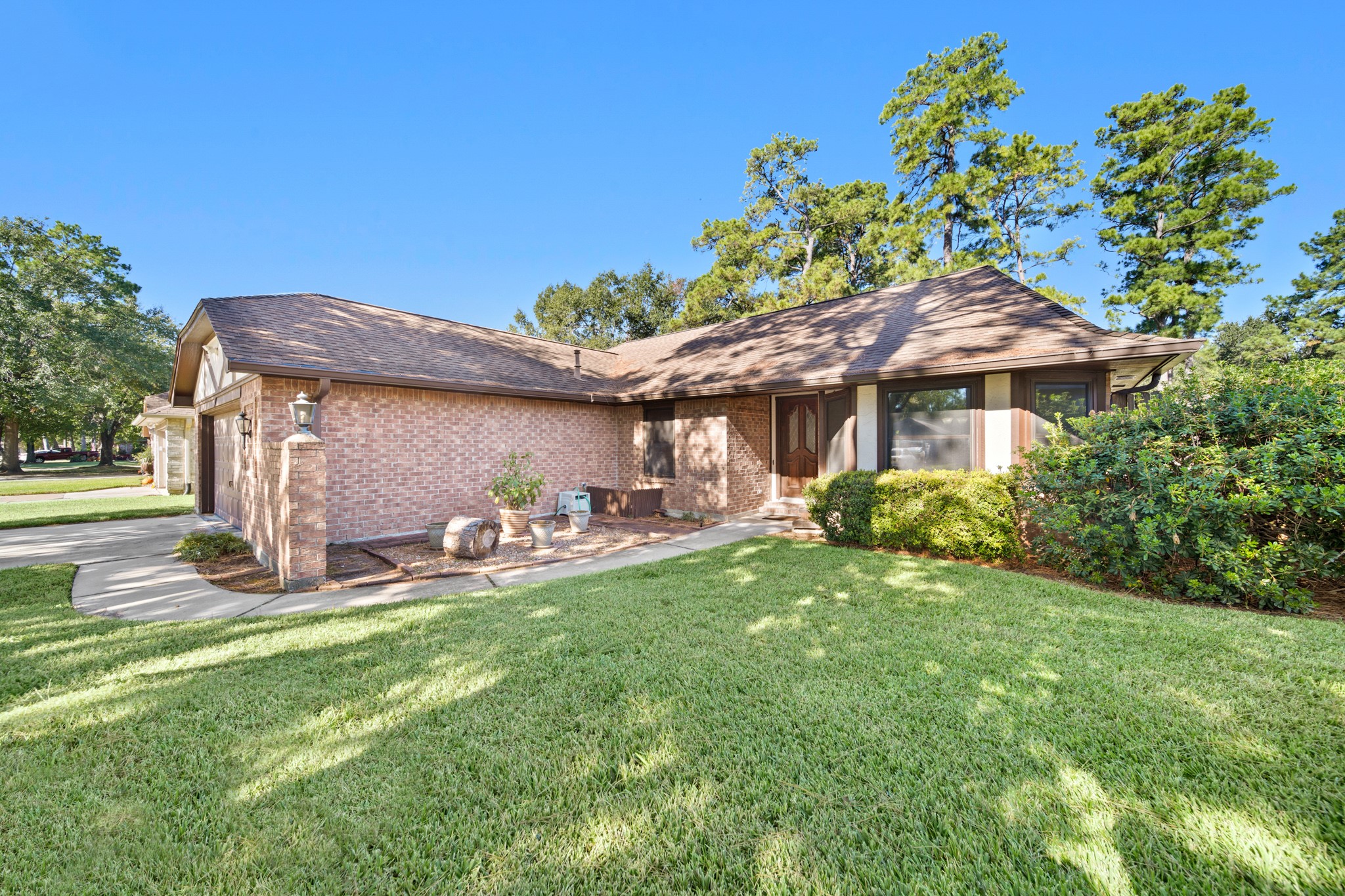 9518 Dundalk Street Spring, TX 77379 - Photo 5 of 46 a front view of a house with a yard table and chairs