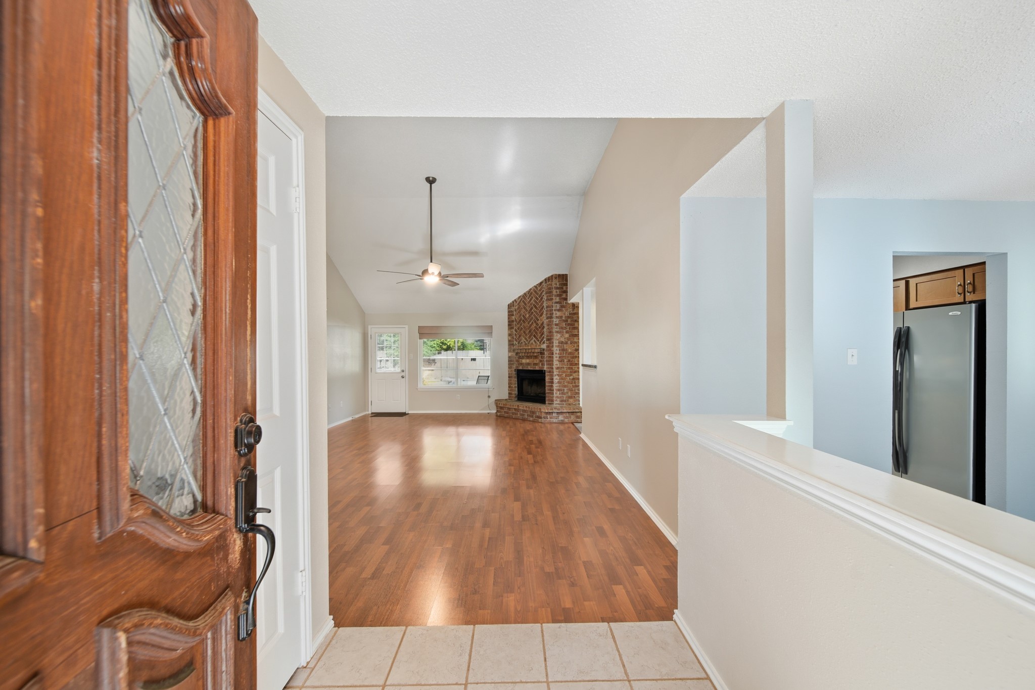 9518 Dundalk Street Spring, TX 77379 - Photo 7 of 46 a view of a hallway with wooden floor and staircase